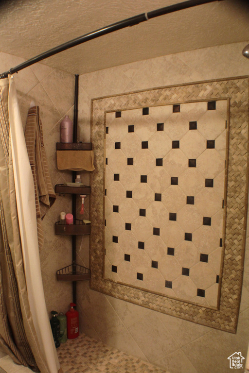 Detailed view of tiled shower and tile walls