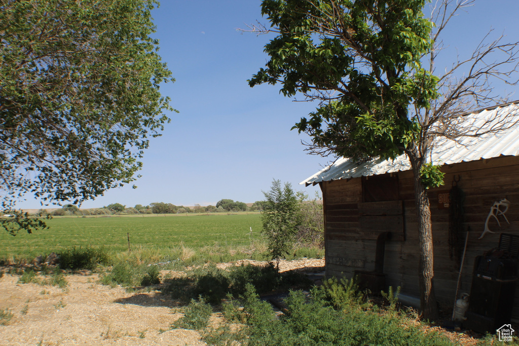View of yard featuring a view of countryside and an outdoor structure