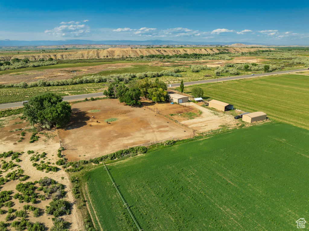 Aerial view of property and surrounding area featuring rural landscape and farmland