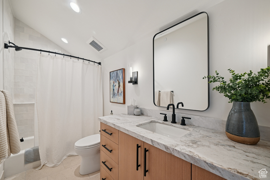 Bathroom with vanity, toilet, shower / tub combo with curtain, vaulted ceiling, and recessed lighting