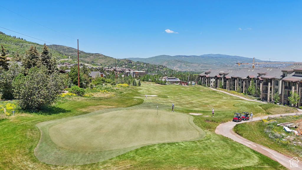 Surrounding community with a mountain view and golf course view