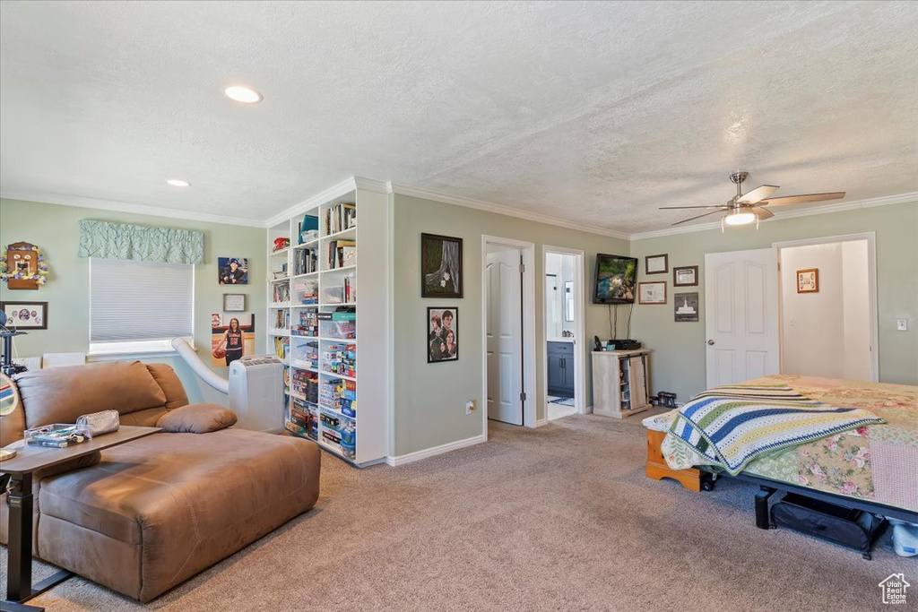Carpeted bedroom featuring a textured ceiling, ornamental molding, a ceiling fan, recessed lighting, and baseboards