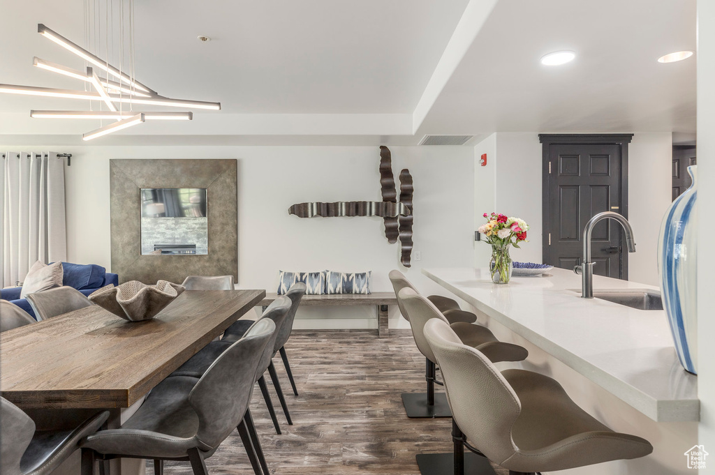 Dining space with dark wood-style floors and recessed lighting