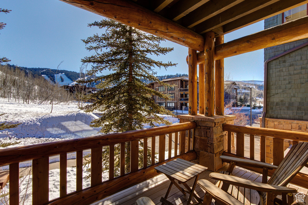 Snow covered deck with a mountain view