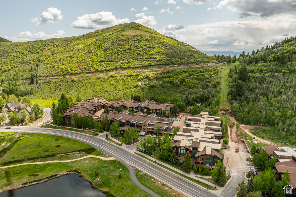 Aerial view of residential area featuring a water and mountain view and a heavily wooded area