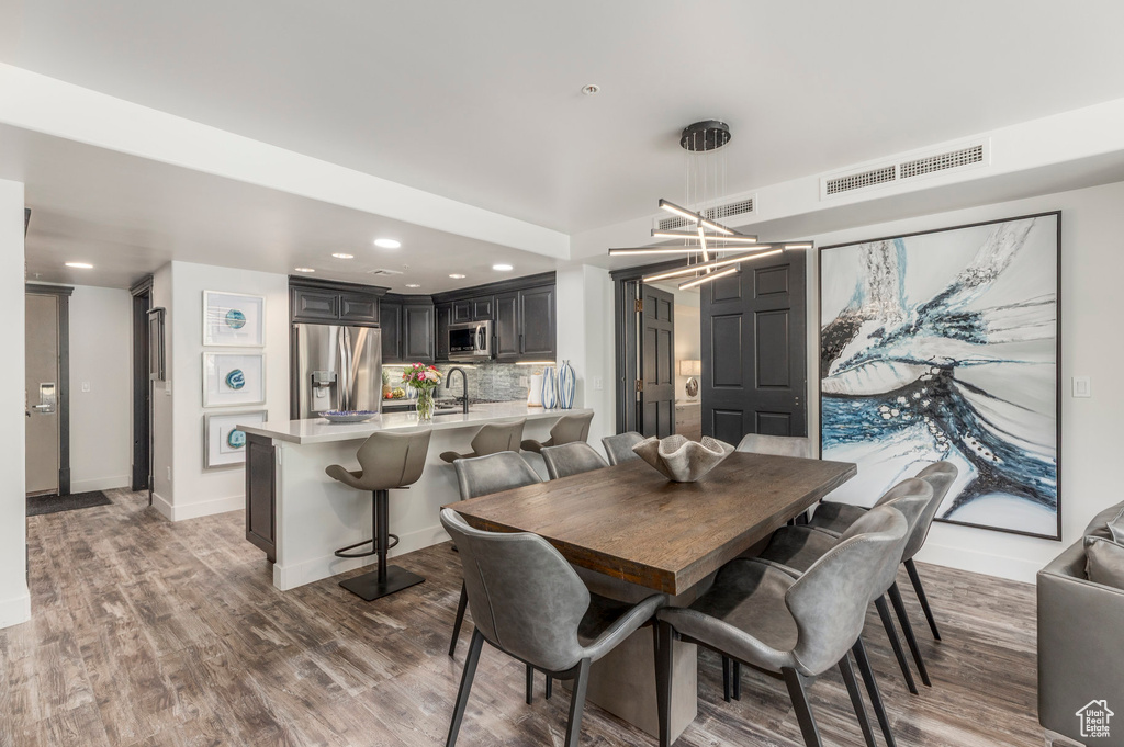 Dining area featuring wood finished floors, recessed lighting, and baseboards