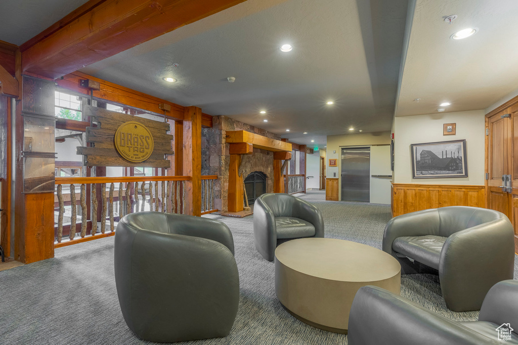 Lobby featuring wood walls, recessed lighting, and wainscoting