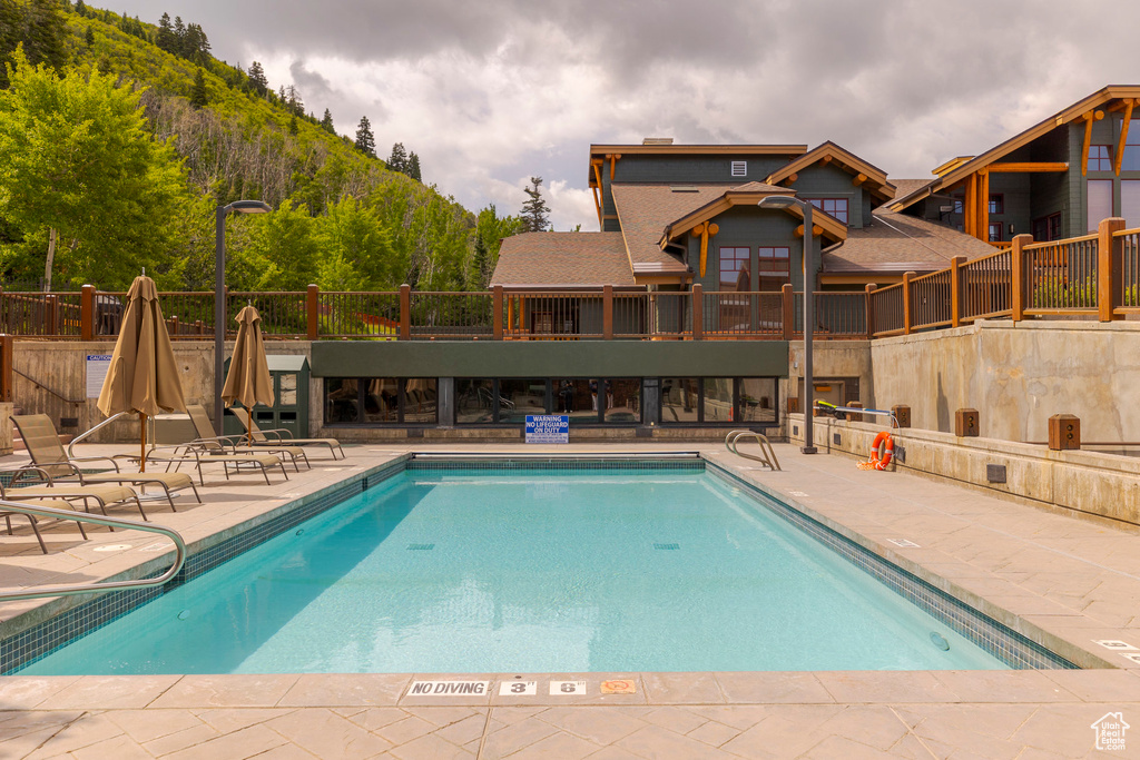 Community pool featuring a patio