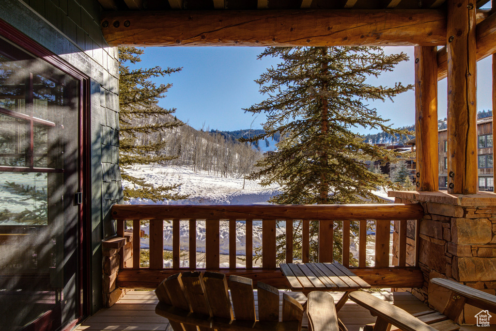 Snow covered deck featuring a mountain view