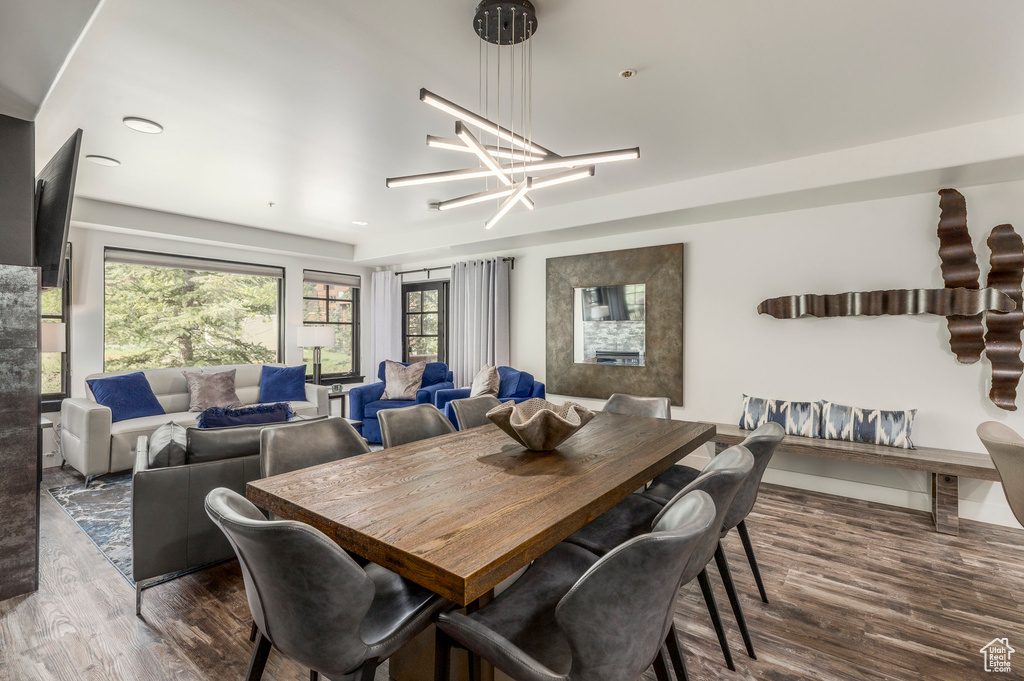 Dining area featuring wood finished floors and a chandelier