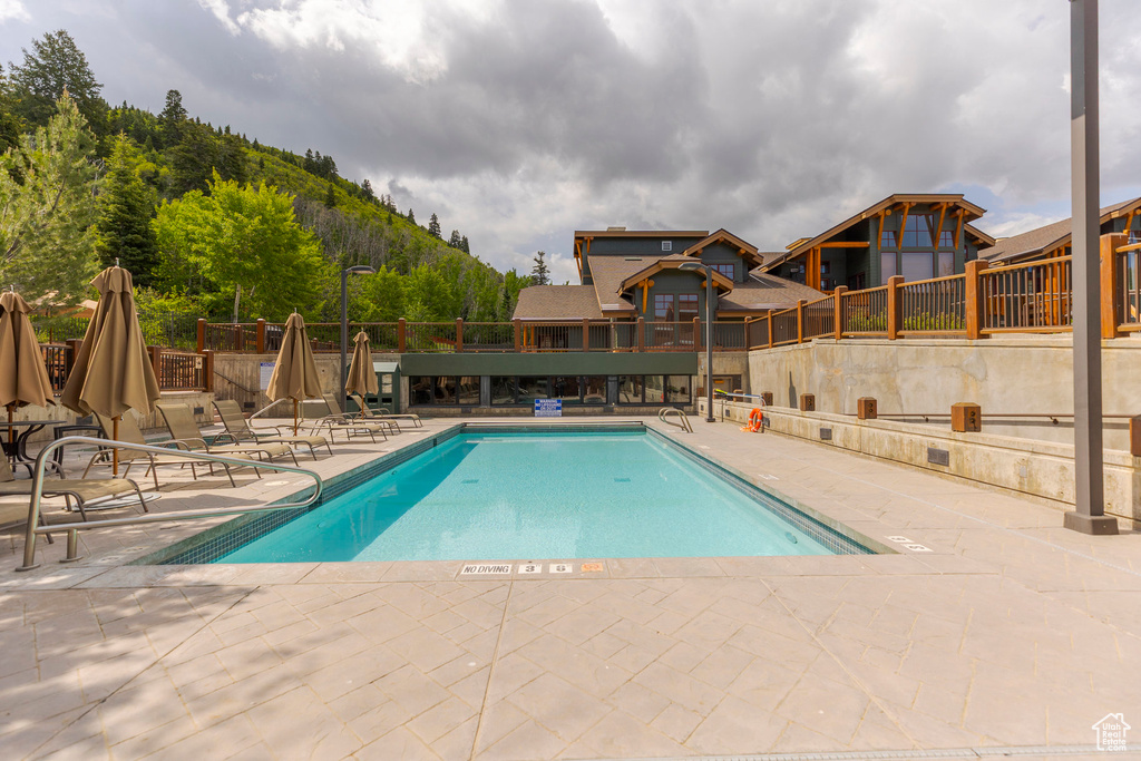Community pool featuring a patio and a mountain view