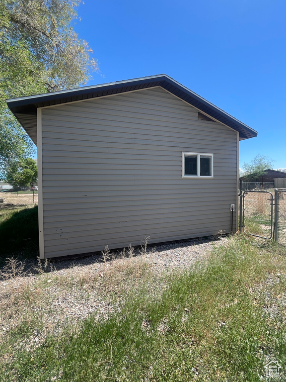 View of property exterior featuring a gate