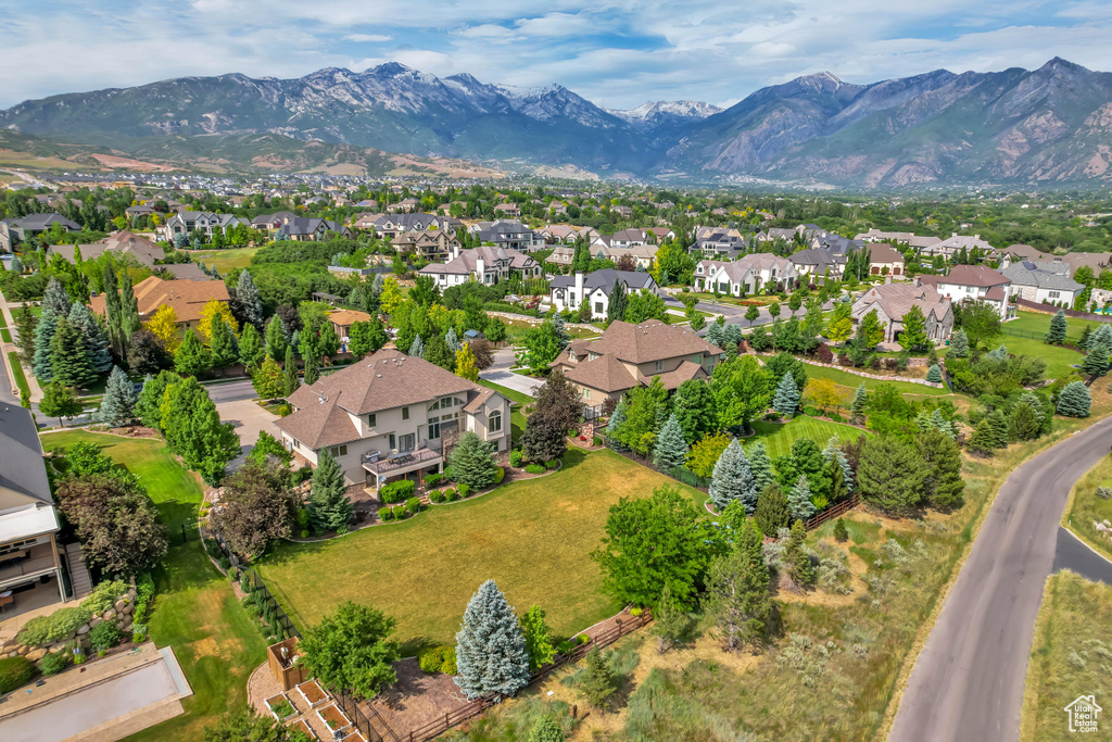 Aerial overview of property's location featuring nearby suburban area and a mountainous background