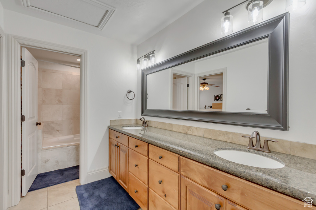 Bathroom featuring double vanity, tile patterned floors, and  shower combination