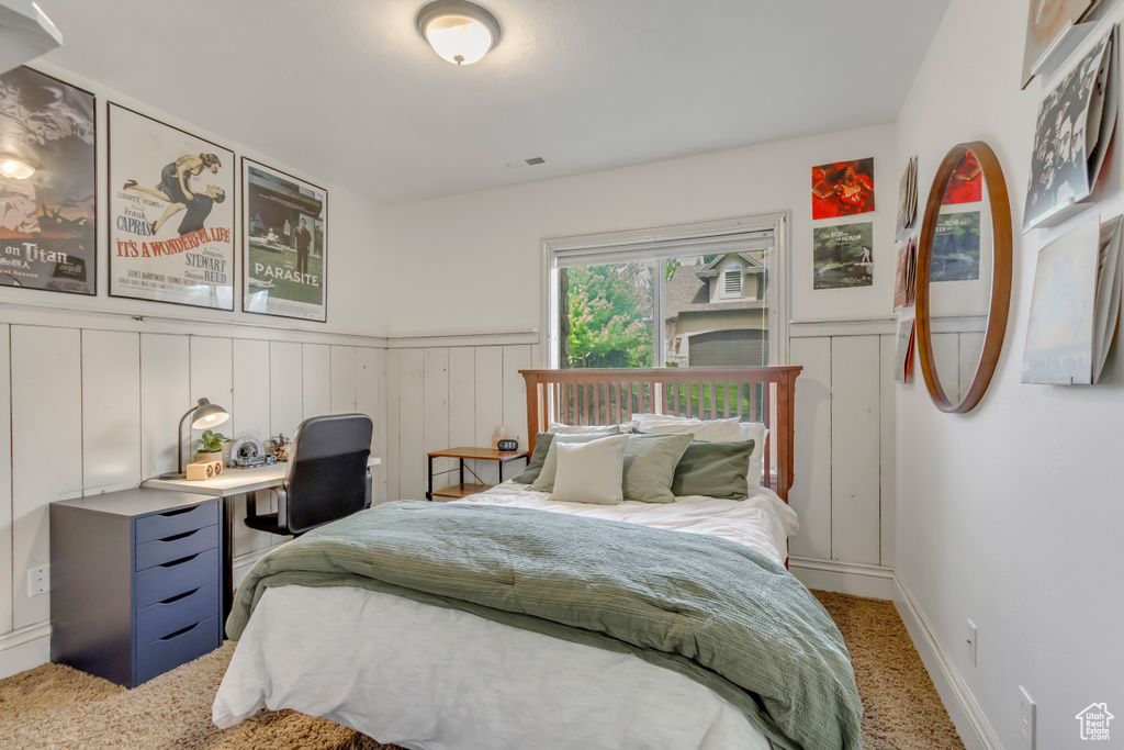 Bedroom featuring wainscoting and carpet floors