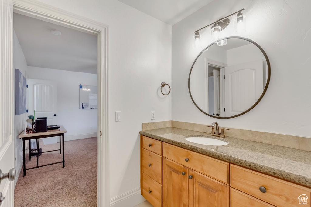 Bathroom with vanity and baseboards
