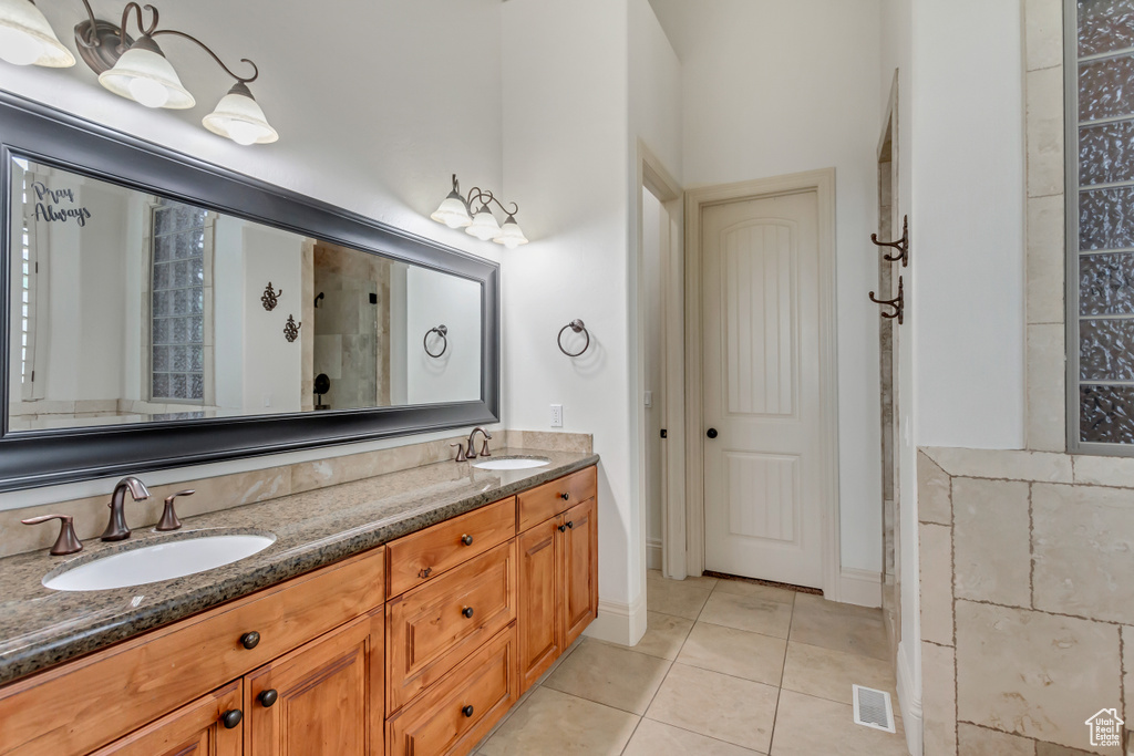Bathroom with double vanity and tile patterned floors