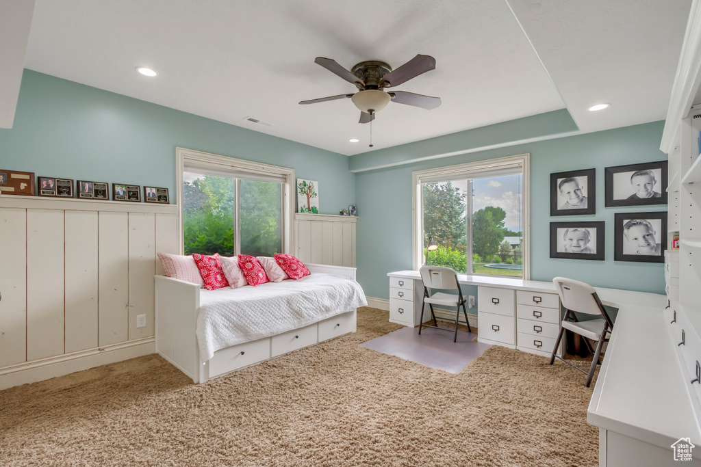 Carpeted bedroom with an office area, recessed lighting, and ceiling fan