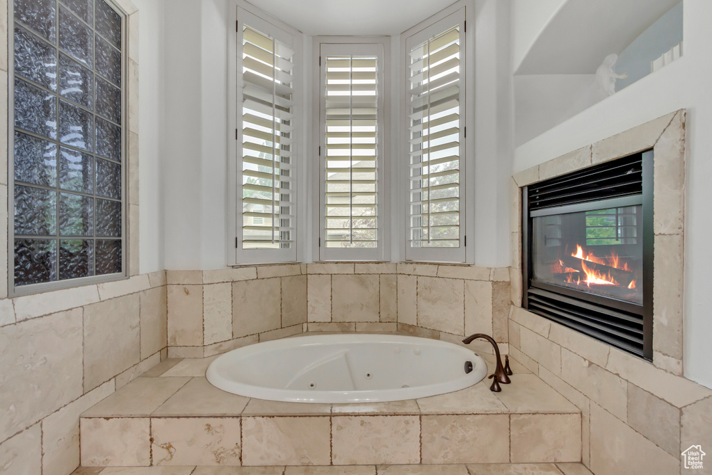 Full bath featuring a tub with jets and plenty of natural light