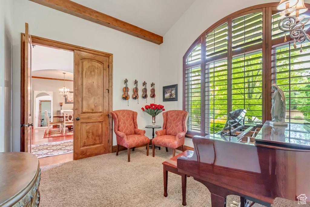Sitting room featuring a chandelier, arched walkways, and beamed ceiling
