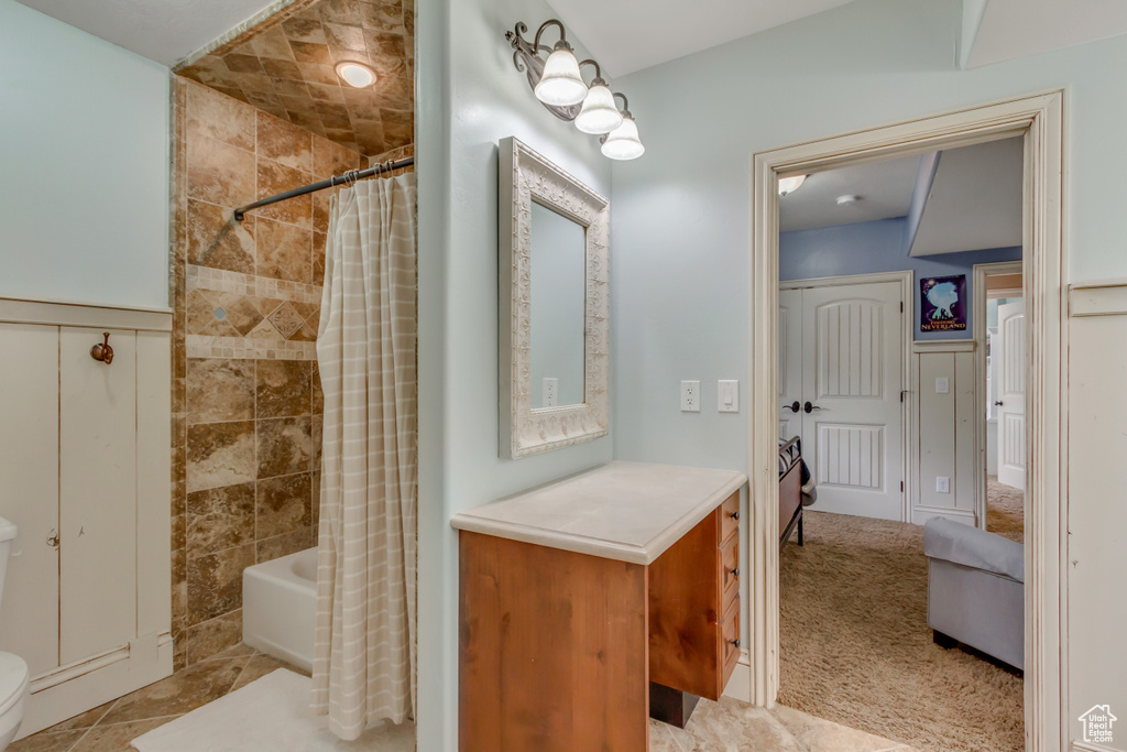 Full bath featuring shower / bath combo and toilet