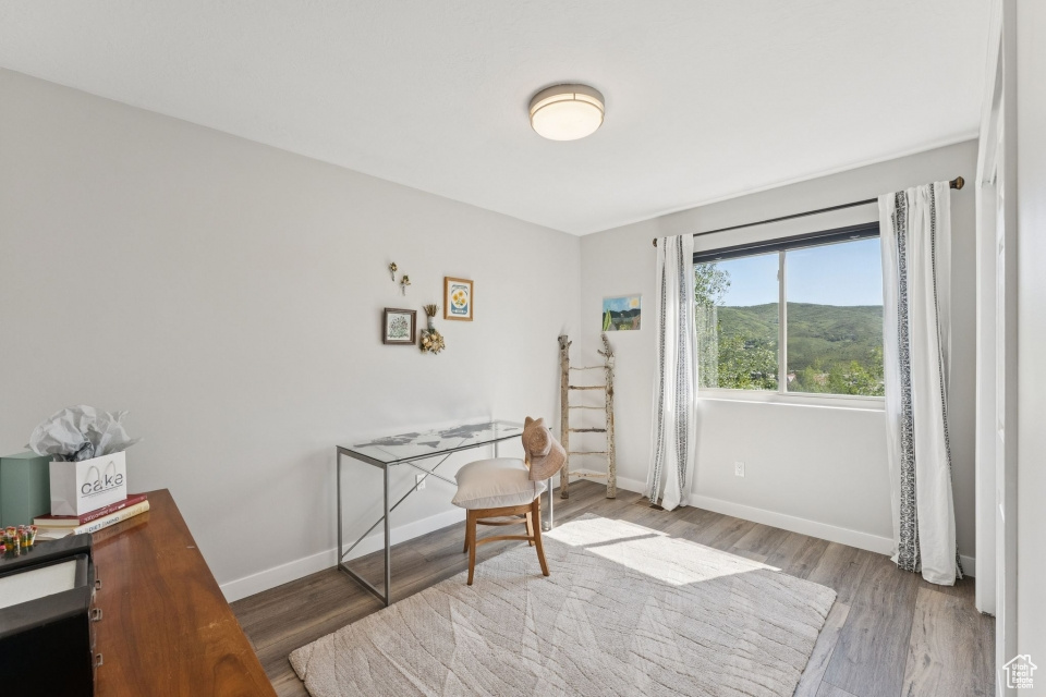 Office with wood finished floors and baseboards