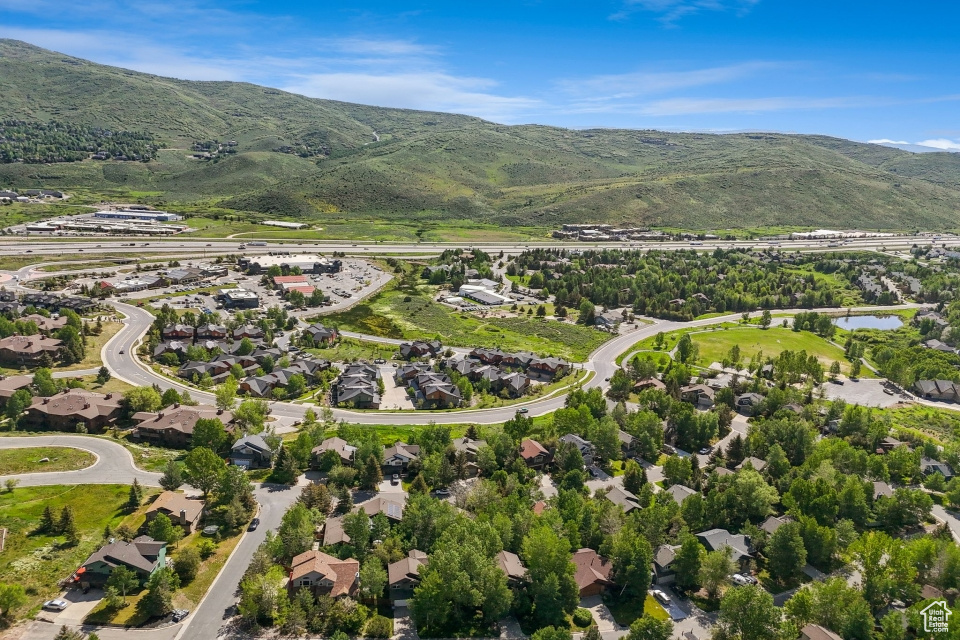 View of property location featuring nearby suburban area and a water and mountain view