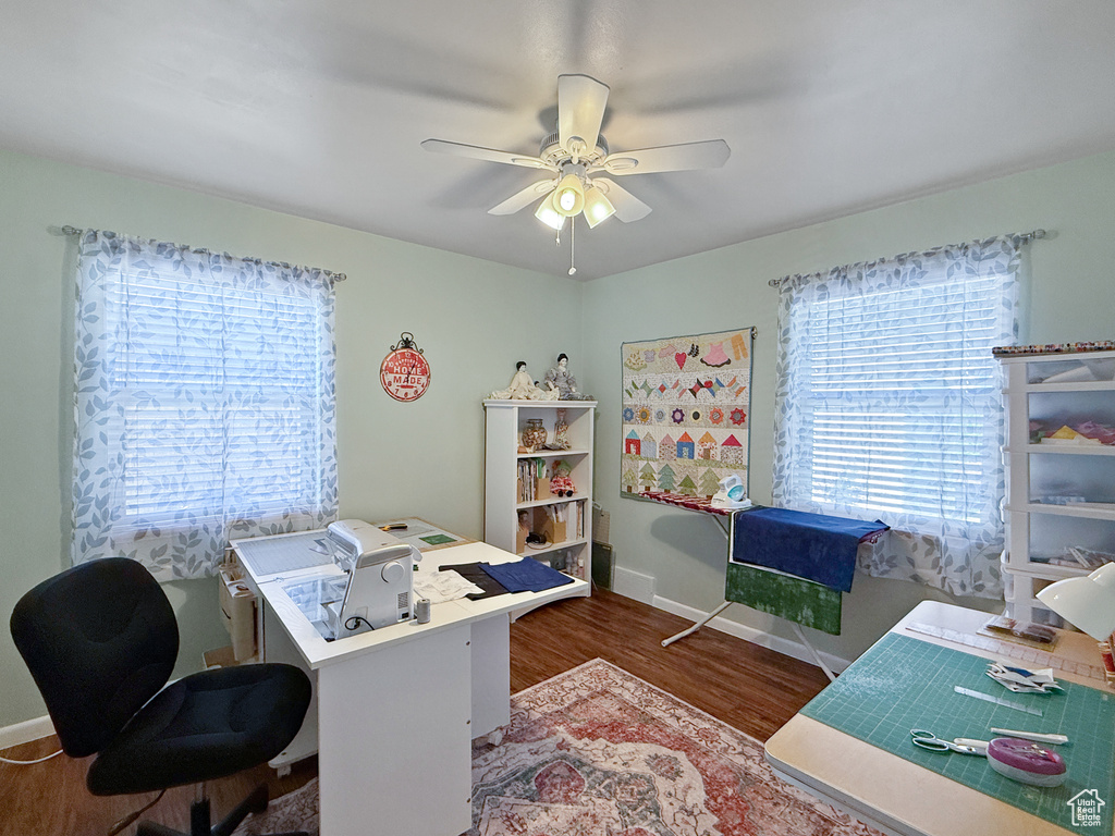 Office area with wood finished floors and ceiling fan