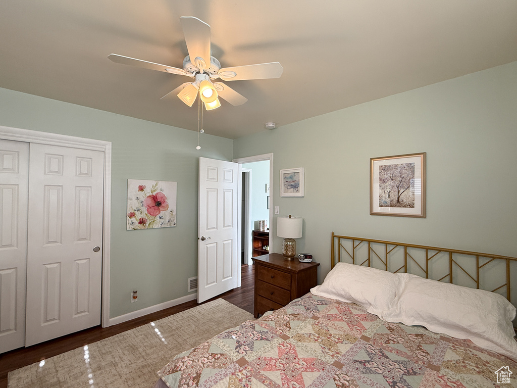 Bedroom with wood finished floors, a closet, and a ceiling fan