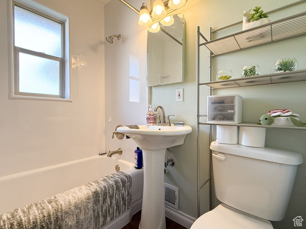 Bathroom featuring bathtub / shower combination and a chandelier
