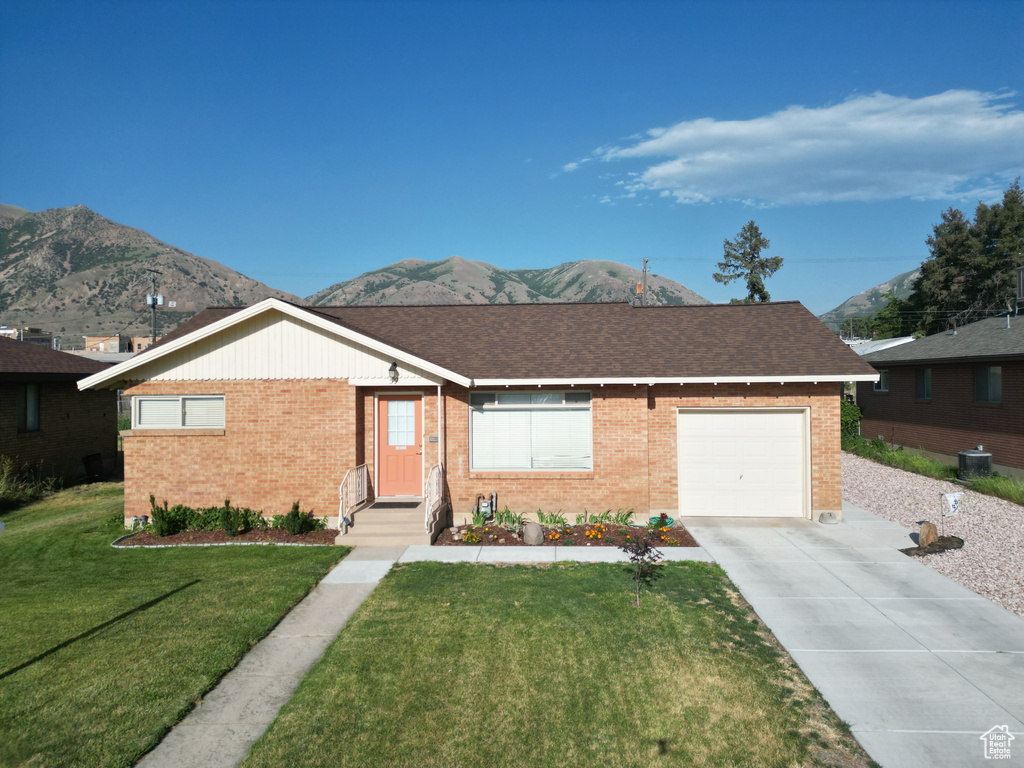 Ranch-style home with brick siding, driveway, and a mountain view