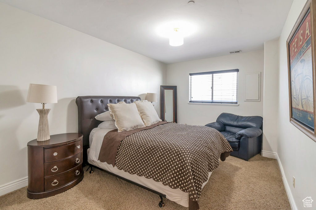 Bedroom featuring carpet flooring and baseboards