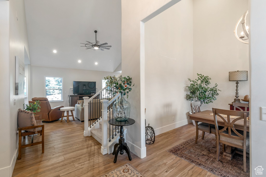 Entryway with wood finished floors, a ceiling fan, high vaulted ceiling, baseboards, and recessed lighting