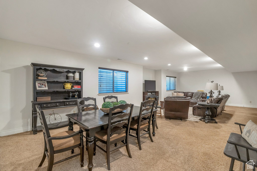 Dining room with light carpet, recessed lighting, and baseboards