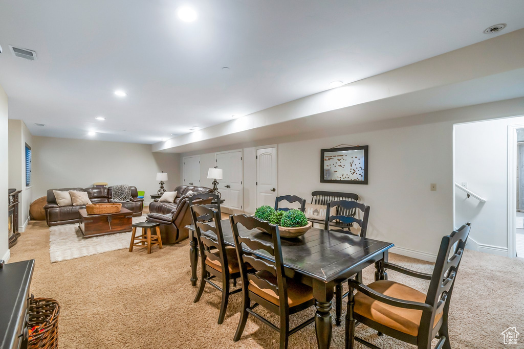 Dining room with light carpet, recessed lighting, and baseboards