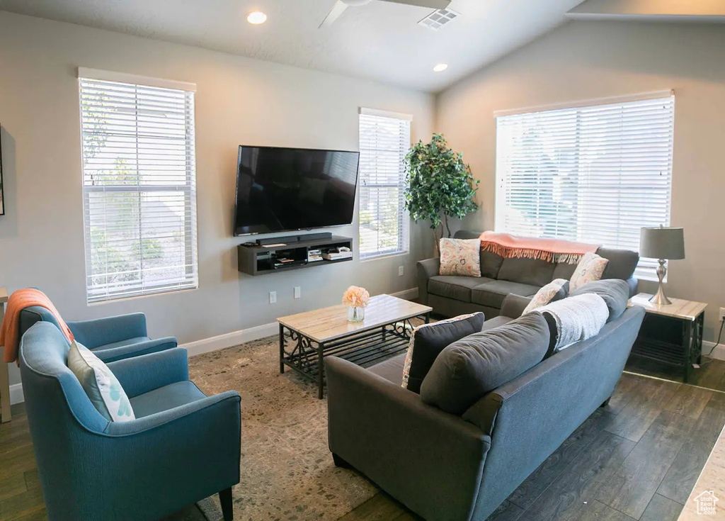 Living area featuring a ceiling fan, baseboards, wood finished floors, recessed lighting, and lofted ceiling