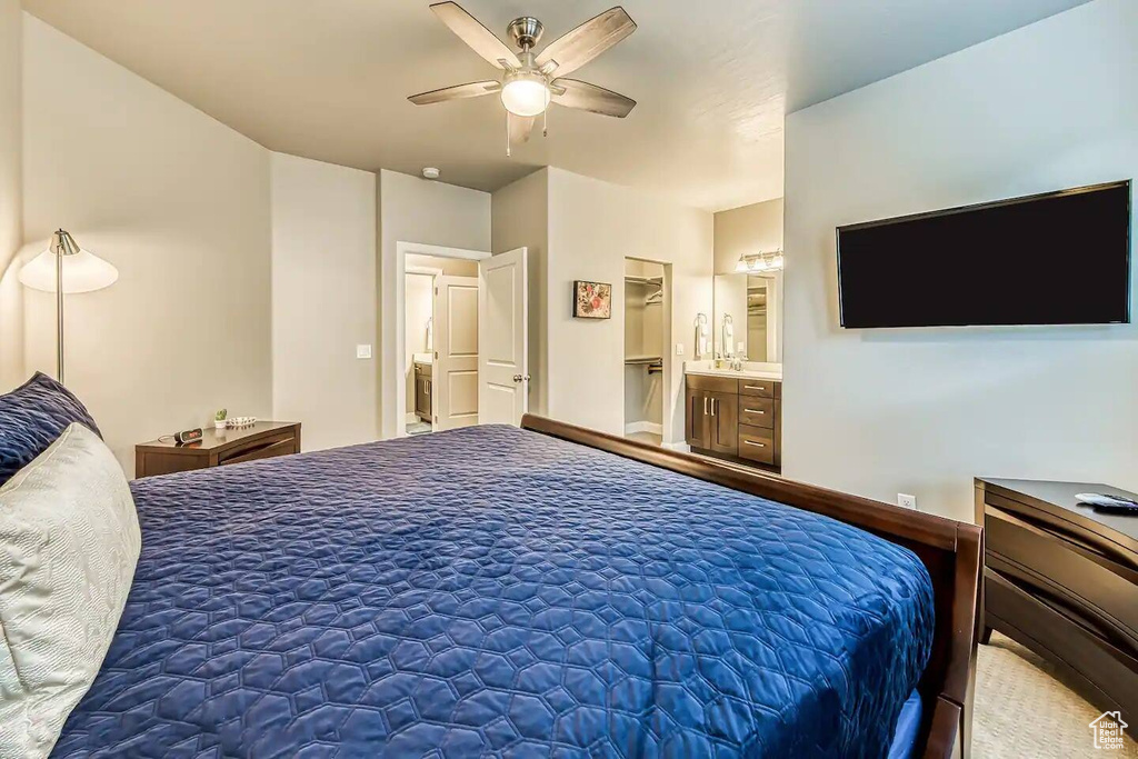Bedroom with ceiling fan and connected bathroom