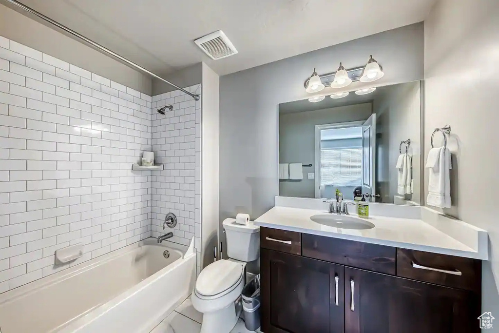Bathroom with vanity,  shower combination, and toilet
