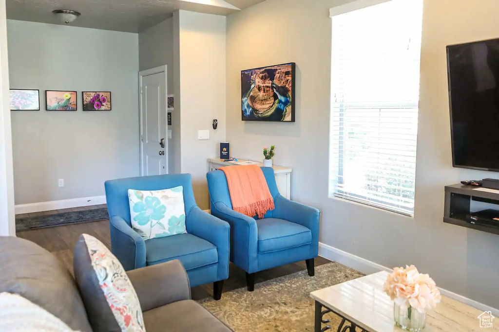 Living area with wood finished floors and baseboards