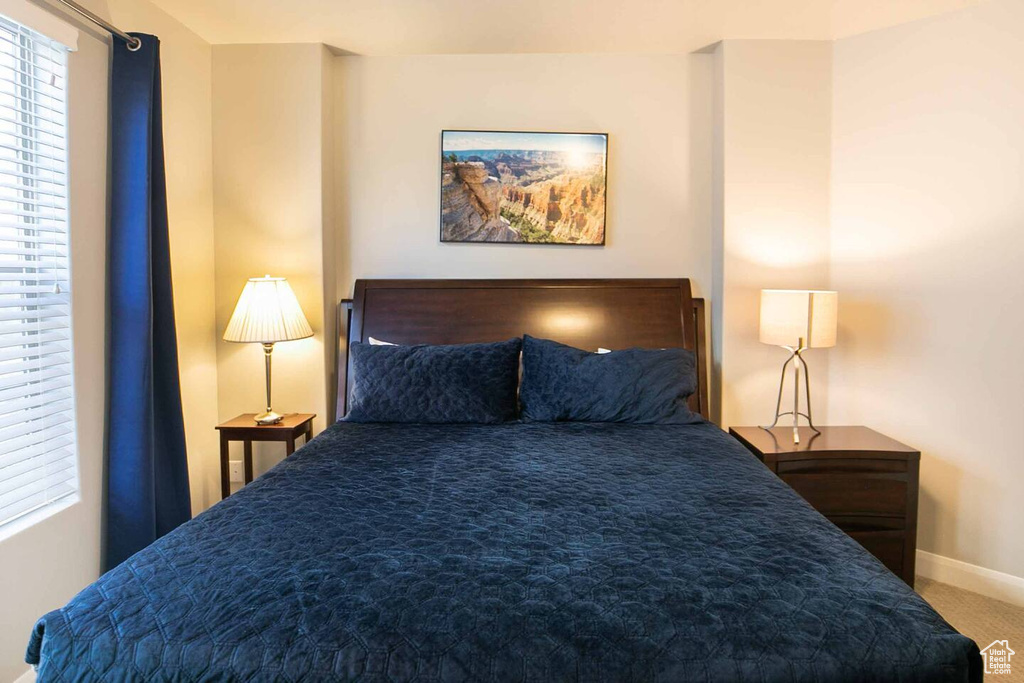 Carpeted bedroom with baseboards