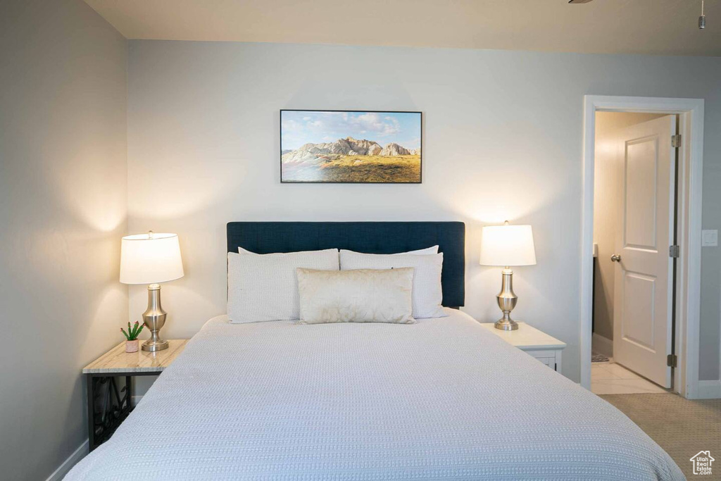 Bedroom featuring baseboards and light colored carpet