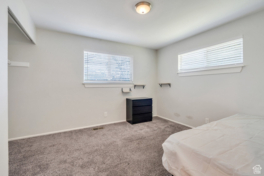 Carpeted bedroom featuring baseboards