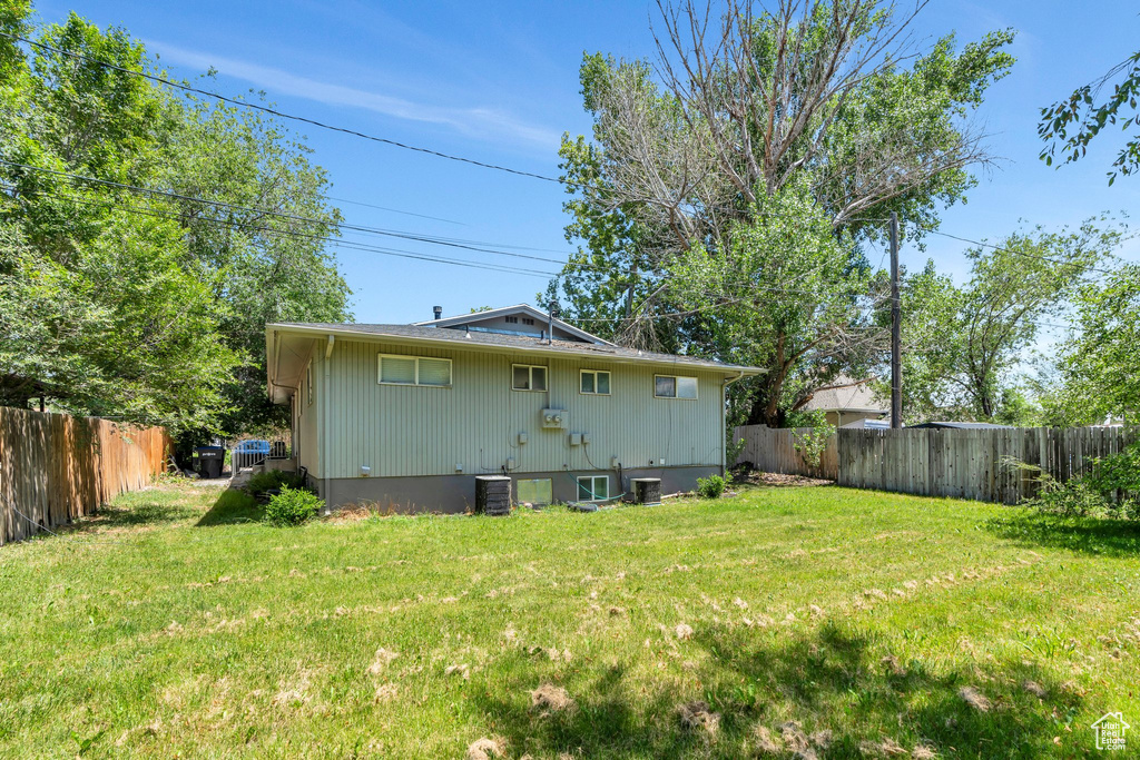 Rear view of house with central AC unit