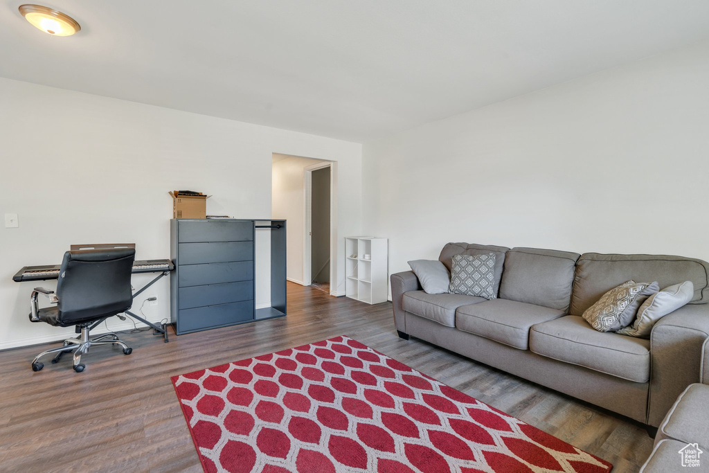 Living area featuring wood finished floors and a desk