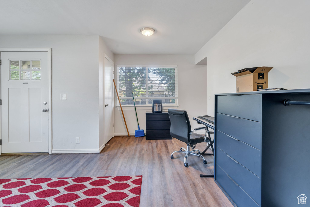 Office space with light wood-style flooring and baseboards