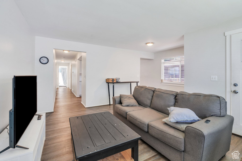 Living area with plenty of natural light and wood finished floors