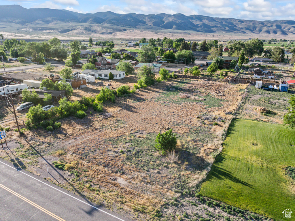 Aerial view of property's location with a mountain backdrop