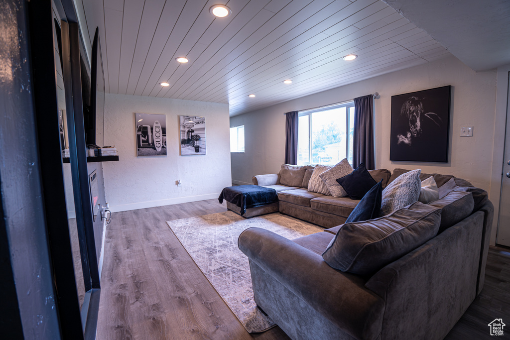 Living room featuring recessed lighting, wood finished floors, wood ceiling, and baseboards