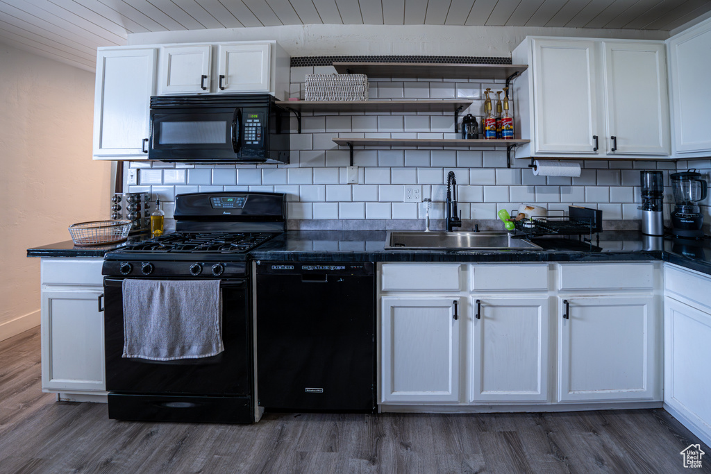 Kitchen featuring black appliances, open shelves, a sink, wooden ceiling, and wood finished floors