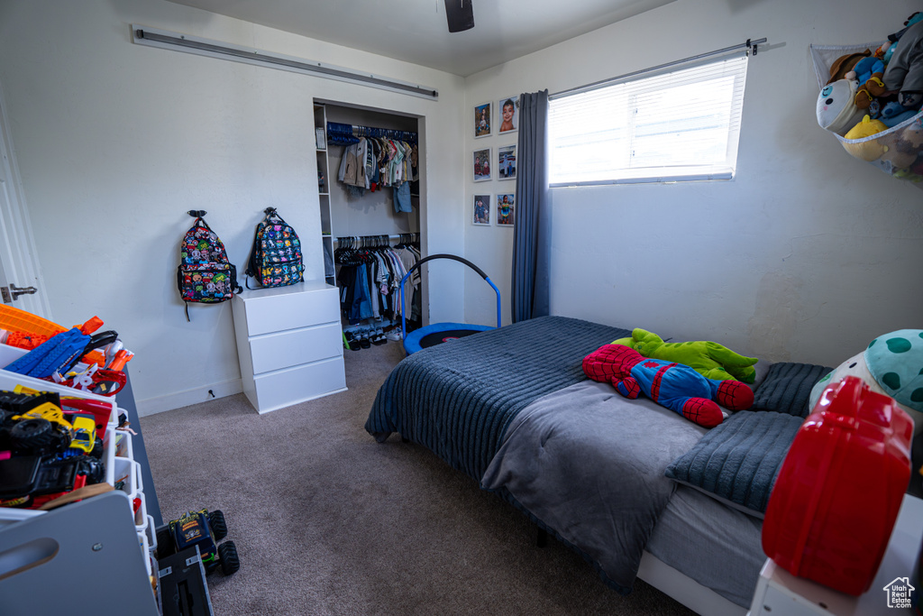 Bedroom with carpet floors, a closet, and a ceiling fan